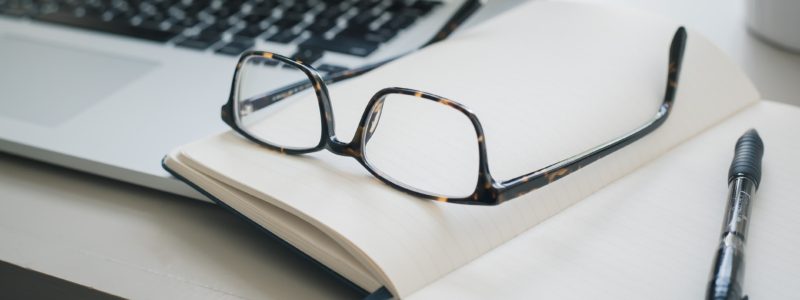 laptop, pen and glasses